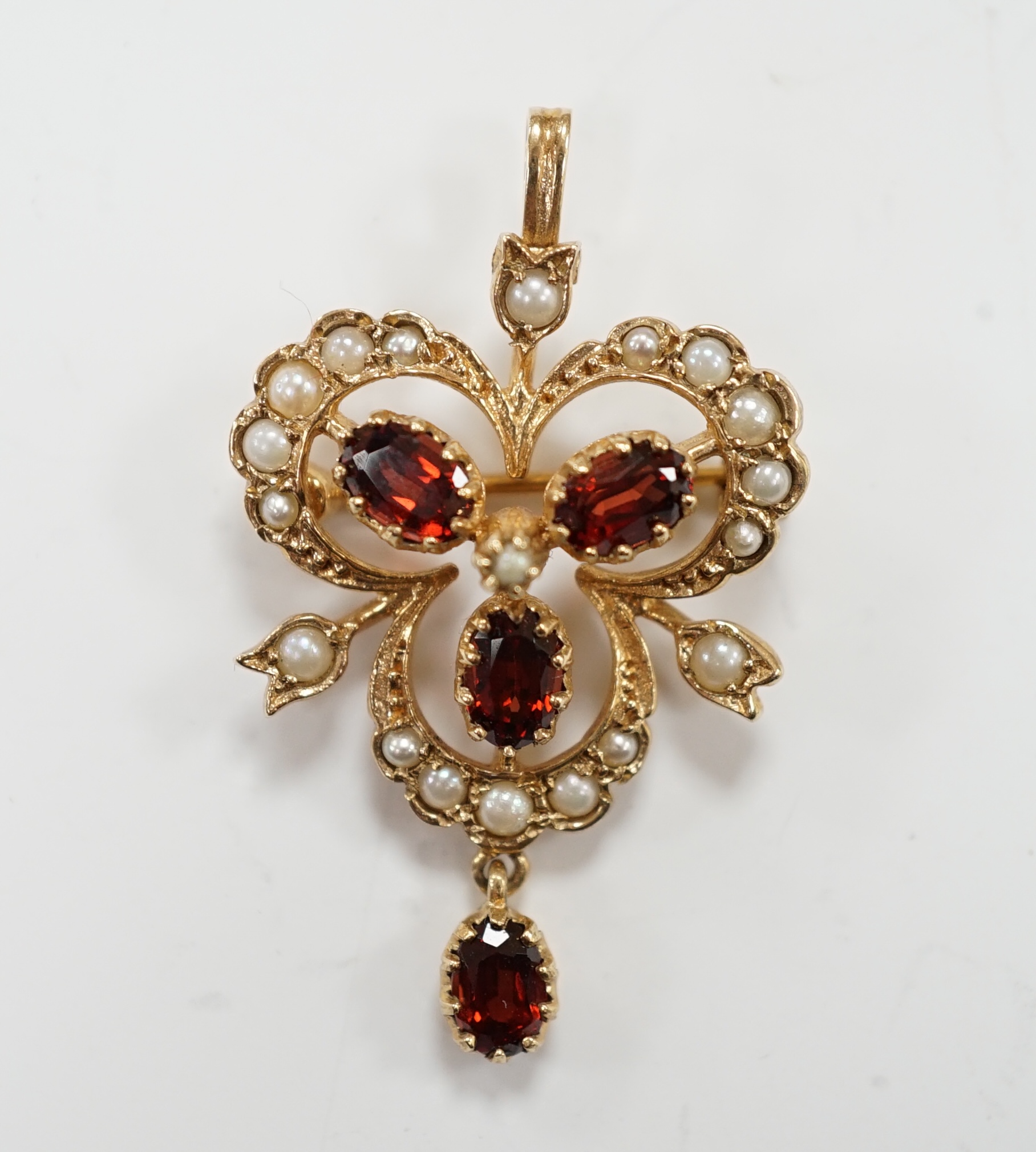 A modern 9ct gold garnet and seed pearl cluster set drop pendant brooch, 39mm, gross weight 4.8 grams.